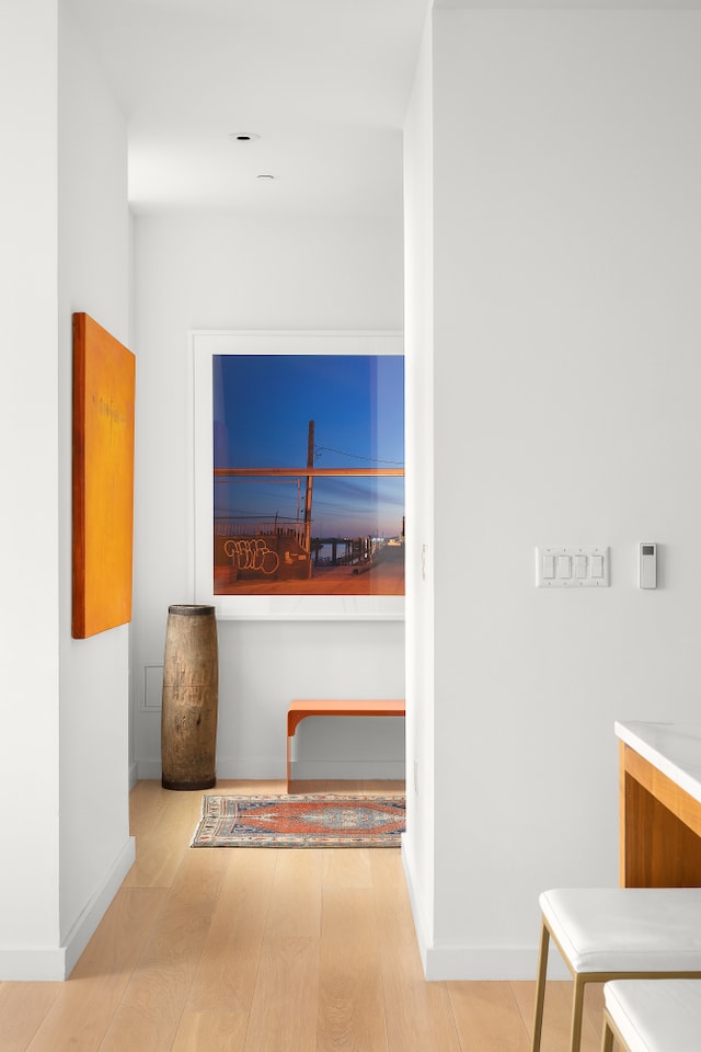 corridor featuring baseboards and wood finished floors