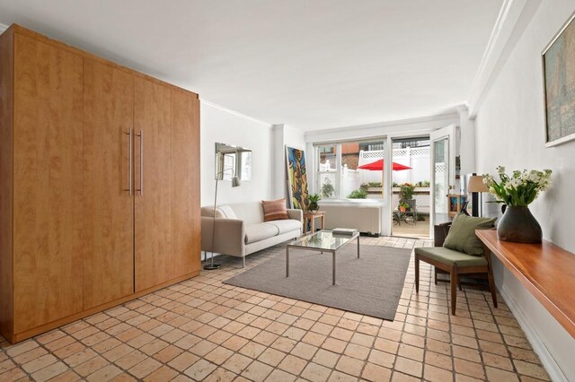living area featuring ornamental molding