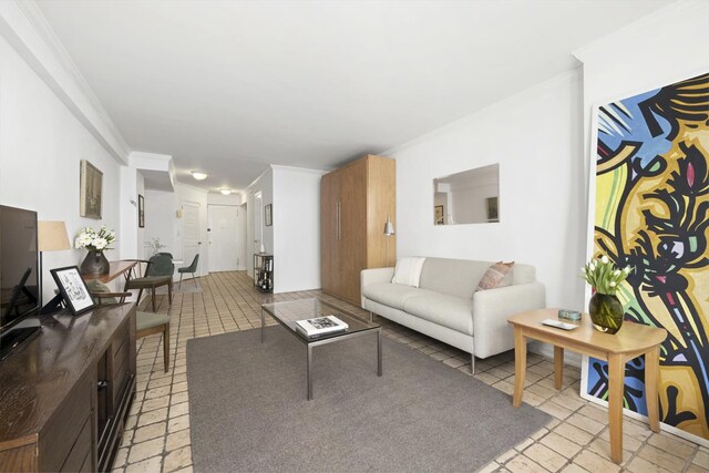 living room with ornamental molding and light tile patterned floors