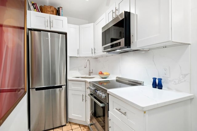 kitchen featuring a sink, white cabinets, and stainless steel appliances
