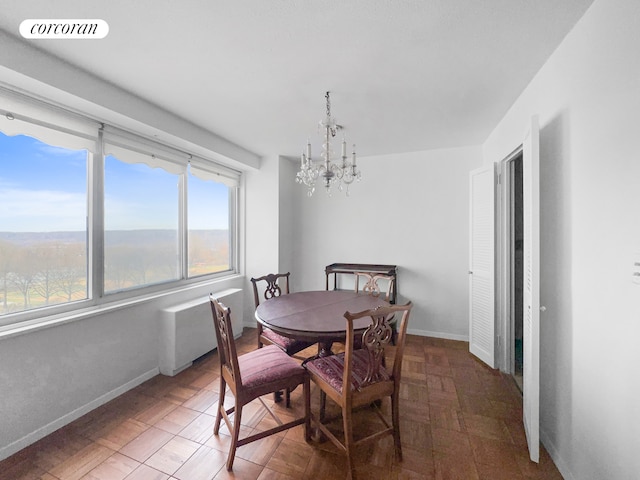 3333 Henry Hudson Pkwy Unit 8L, New York City, NY 10463 - dining space with a chandelier and radiator heating unit