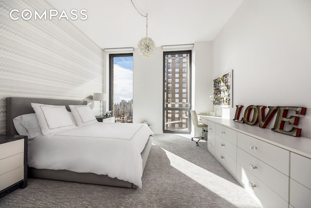 360 E 89th St Unit 29B, New York City, NY 10128 - bedroom featuring carpet floors, a wall of windows, and access to exterior