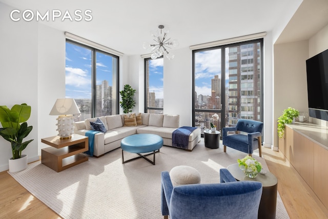 360 E 89th St Unit 29B, New York City, NY 10128 - living area with floor to ceiling windows, light wood finished floors, and a chandelier