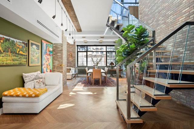 360 W 36th St Unit Ph12, New York City, NY 10018 - community lobby with brick wall, stairway, and a high ceiling