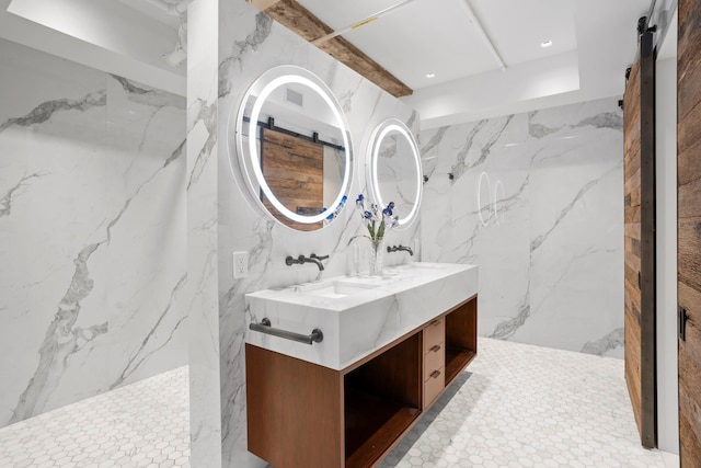 360 W 36th St Unit Ph12, New York City, NY 10018 - bathroom featuring double vanity, stone wall, and recessed lighting