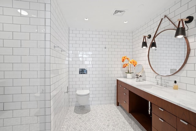 360 W 36th St Unit Ph12, New York City, NY 10018 - bathroom with tile walls, vanity, toilet, tile patterned floors, and a tile shower