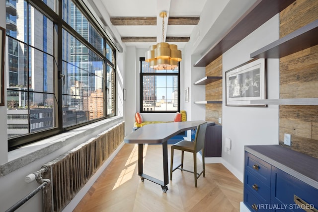 360 W 36th St Unit Ph12, New York City, NY 10018 - dining space with beamed ceiling, a chandelier, and baseboards