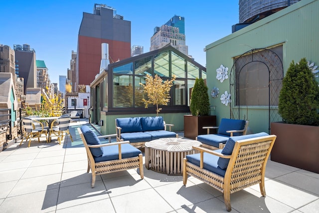 360 W 36th St Unit Ph12, New York City, NY 10018 - view of patio with a skyline view and an outdoor living space