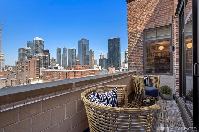 360 W 36th St Unit Ph12, New York City, NY 10018 - view of patio with a balcony and a skyline view