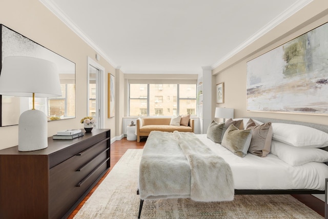 bedroom with crown molding, multiple windows, and wood finished floors