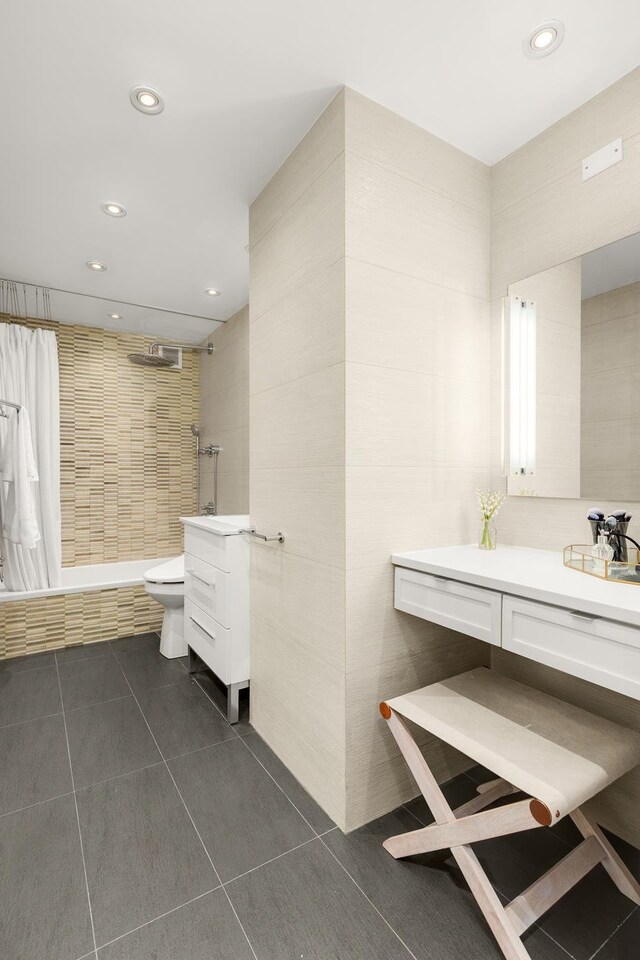 230 E 79th St Unit 12Cd, New York City, NY 10021 - full bath featuring vanity, recessed lighting, toilet, tile walls, and tiled shower / bath combo