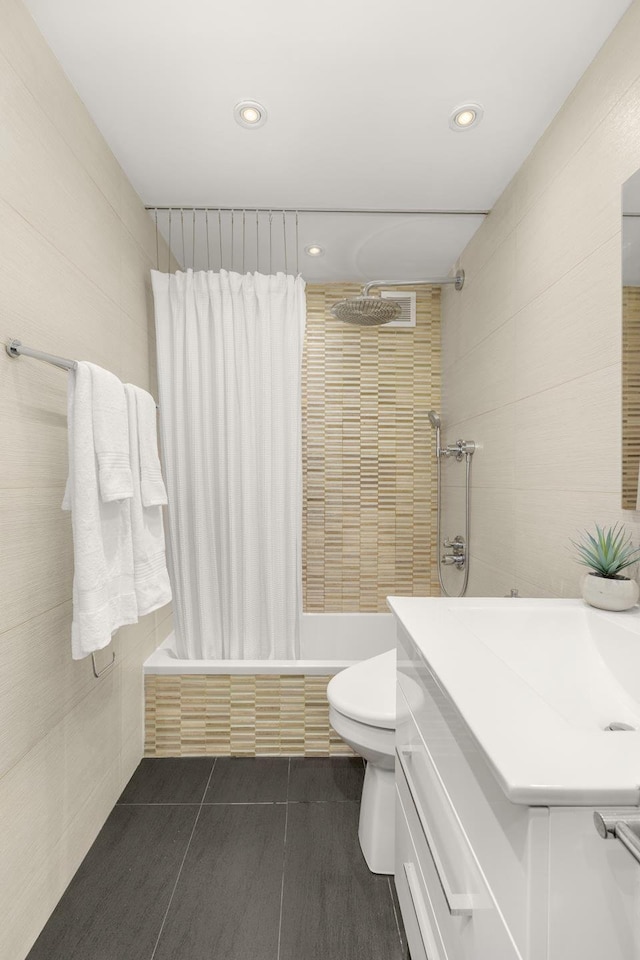 230 E 79th St Unit 12Cd, New York City, NY 10021 - full bath featuring tiled shower / bath, recessed lighting, toilet, tile patterned floors, and vanity