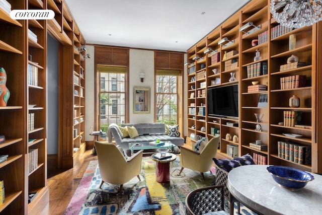 159 E 61st St, New York City, NY 10065 - living area featuring wood-type flooring, built in features, and bookshelves