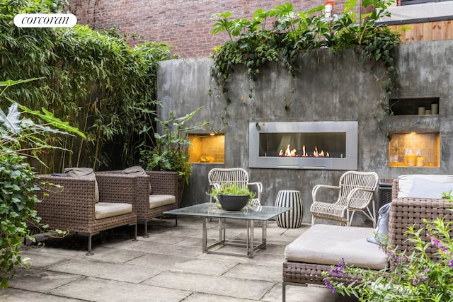159 E 61st St, New York City, NY 10065 - view of patio featuring a warm lit fireplace