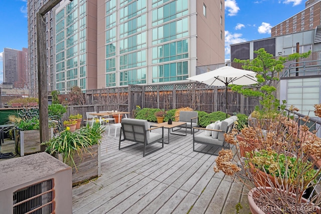 407 E 91st St Unit 5F, New York City, NY 10128 - wooden terrace with outdoor lounge area