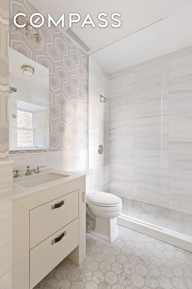 100 W 80th St Unit 5B, New York City, NY 10024 - bathroom featuring toilet, a tile shower, and vanity