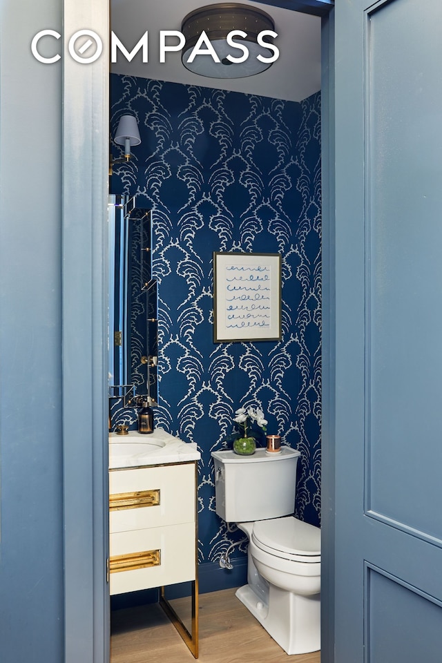 100 W 80th St Unit 5B, New York City, NY 10024 - bathroom featuring wallpapered walls, wood finished floors, toilet, and vanity