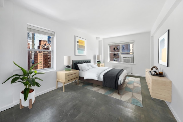 bedroom with baseboards, radiator, and cooling unit
