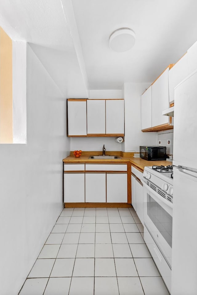 kitchen with light countertops, white cabinetry, a sink, and white appliances
