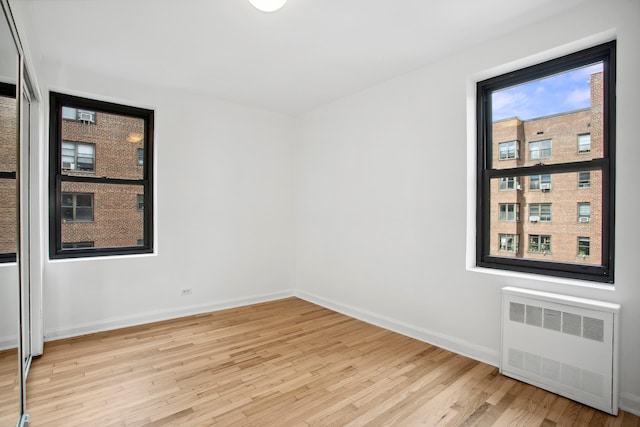 4489 Broadway Unit 5E, New York City, NY 10040 - unfurnished room featuring radiator heating unit and wood finished floors