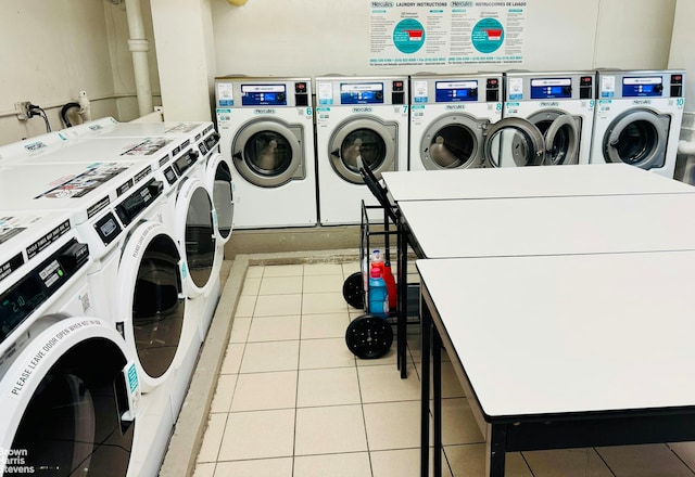 communal laundry room with washing machine and dryer and tile patterned floors