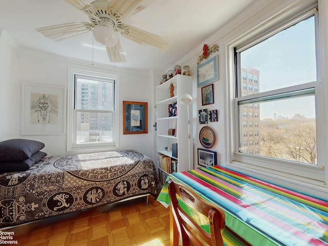 bedroom with crown molding and a ceiling fan