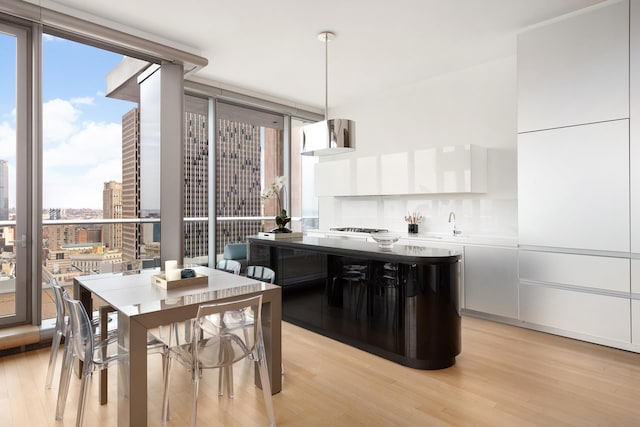 56 Leonard St Unit 29Ae, New York City, NY 10013 - dining space with light wood finished floors, plenty of natural light, and expansive windows
