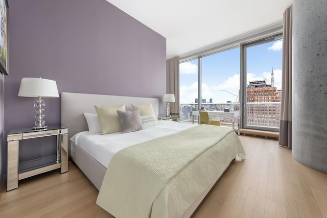 56 Leonard St Unit 29Ae, New York City, NY 10013 - bedroom with floor to ceiling windows, wood finished floors, and a view of city