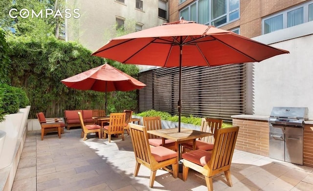 view of patio / terrace with area for grilling, outdoor dining area, grilling area, and an outdoor living space
