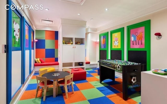 recreation room featuring tile patterned floors, crown molding, and recessed lighting