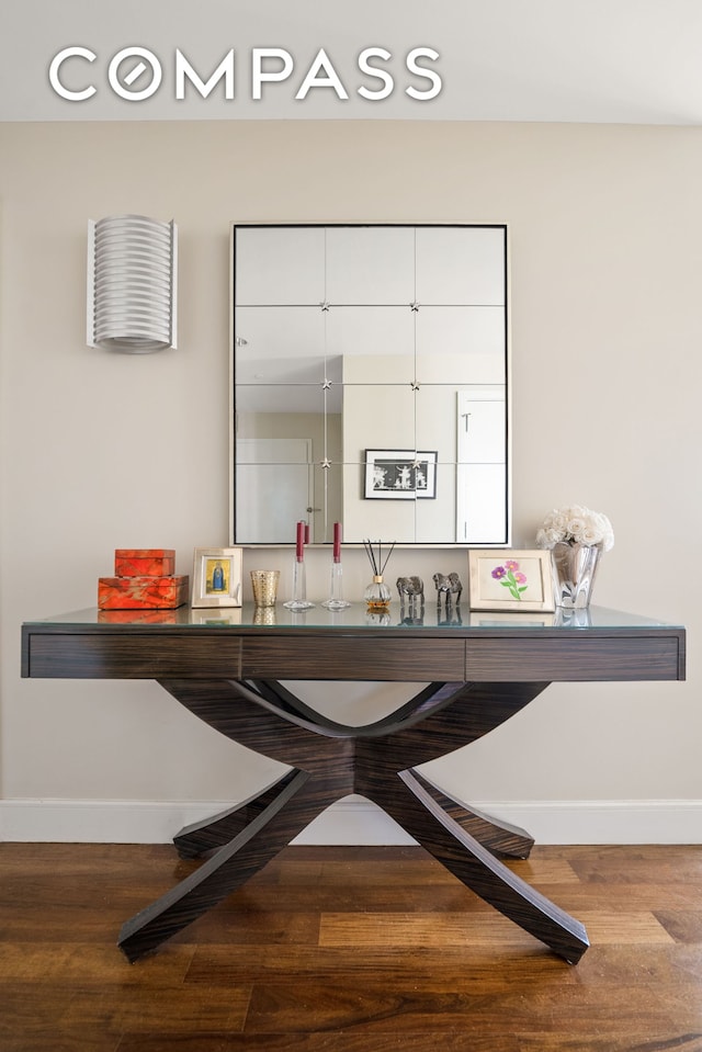 bar featuring baseboards and wood finished floors