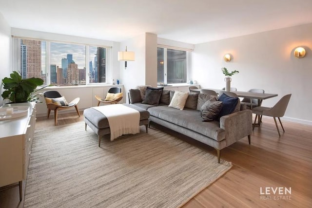 living area featuring light wood-style flooring and baseboards