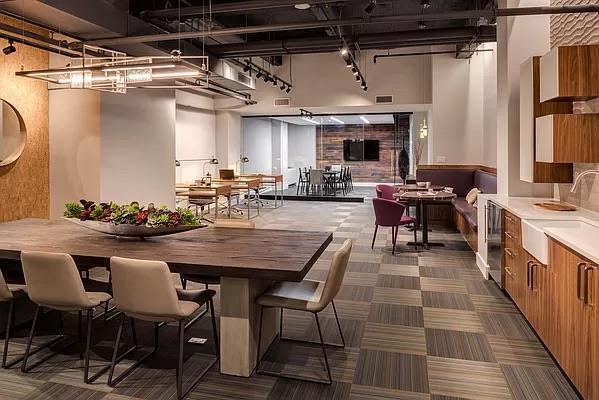 dining space with a towering ceiling, dark colored carpet, and visible vents