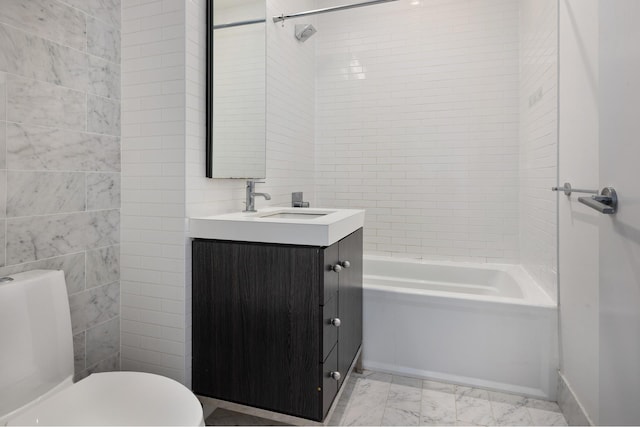 full bathroom featuring toilet, vanity, marble look tiles, tile walls, and washtub / shower combination