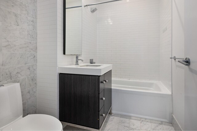 416 W 52nd St Unit 704, New York City, NY 10019 - bathroom with vanity, toilet, washtub / shower combination, marble finish floors, and tile walls