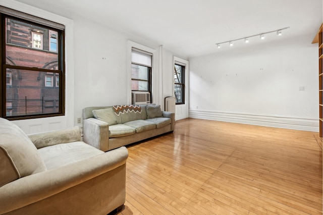 living room with baseboards and light wood-style floors