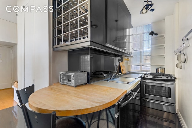11 W 81st St Unit 6A, New York City, NY 10024 - kitchen featuring a sink, dark cabinets, and gas range