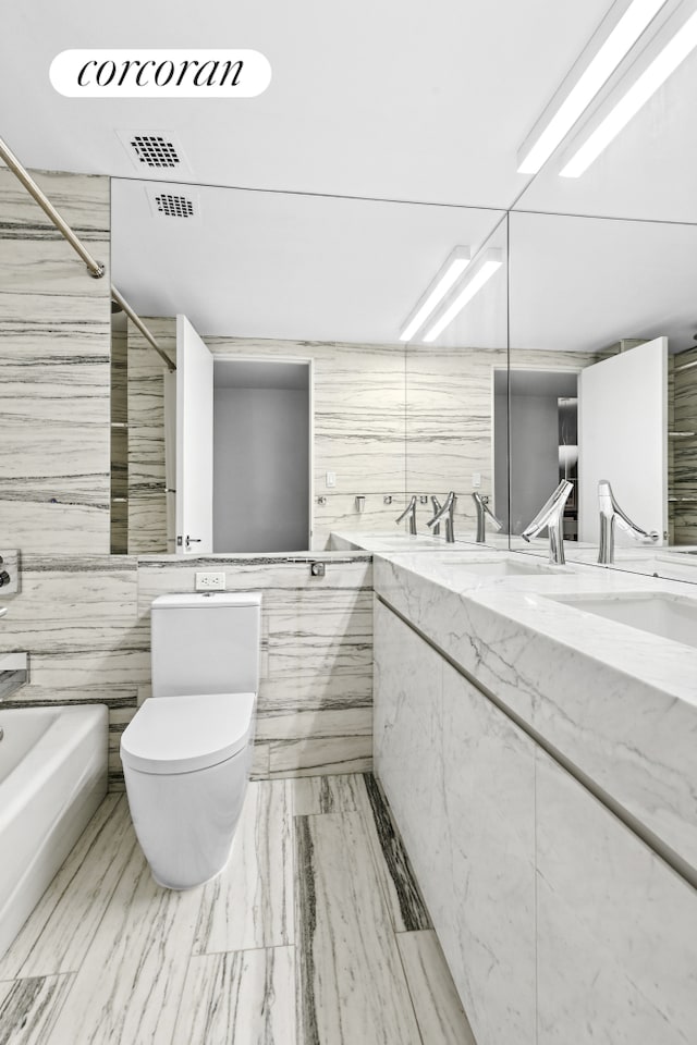 full bath with toilet, double vanity, washtub / shower combination, and visible vents