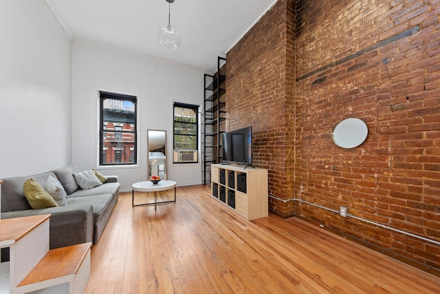 331 E 92nd St Unit 5C, New York City, NY 10128 - living room with hardwood / wood-style flooring and brick wall