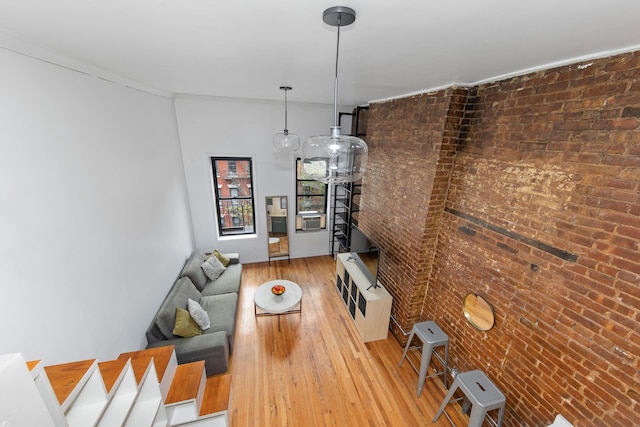 331 E 92nd St Unit 5C, New York City, NY 10128 - living area featuring brick wall and light wood finished floors