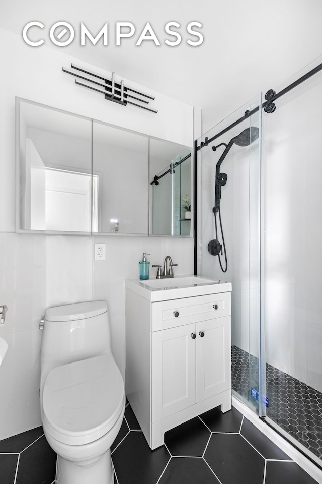 full bath featuring vanity, toilet, tile patterned floors, and a stall shower