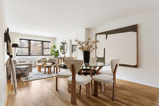 140 7th Ave Unit 4L, New York City, NY 10011 - dining space featuring wood finished floors