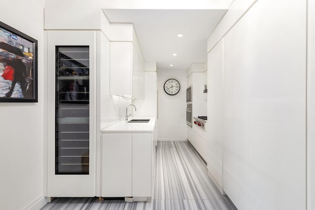 111 W 67th St Unit 34C, New York City, NY 10023 - indoor wet bar featuring wine cooler, oven, recessed lighting, light wood finished floors, and built in microwave