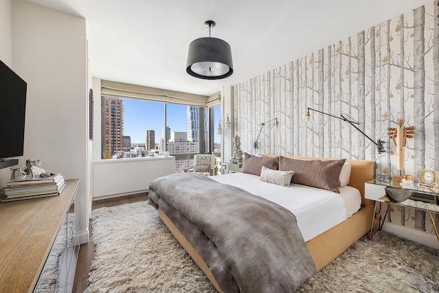 111 W 67th St Unit 34C, New York City, NY 10023 - bedroom with a view of skyline and wood finished floors