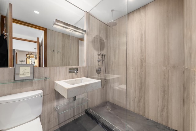 111 W 67th St Unit 34C, New York City, NY 10023 - bathroom with a walk in shower, tile walls, toilet, and a sink