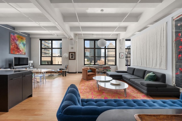 448 W 37th St Unit 9A, New York City, NY 10018 - living area featuring light wood-style floors and beamed ceiling