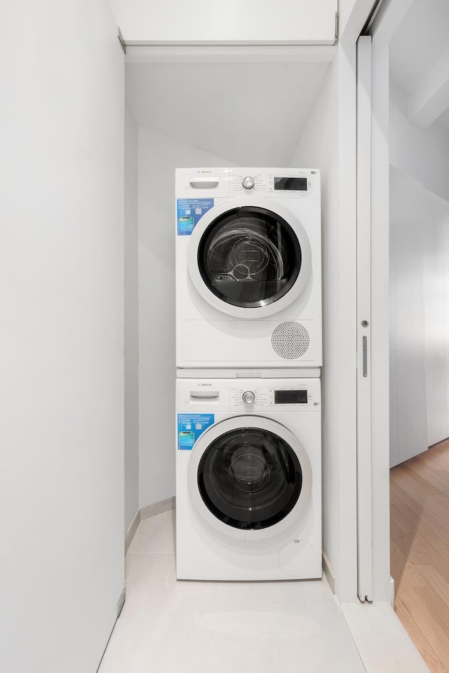 448 W 37th St Unit 9A, New York City, NY 10018 - laundry room featuring stacked washer and clothes dryer
