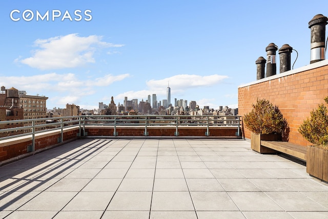 view of patio / terrace with a view of skyline and a balcony