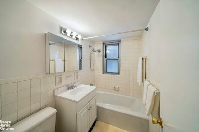 330 E 49th St Unit 3L, New York City, NY 10017 - bathroom featuring toilet, tile walls, vanity, and bathing tub / shower combination