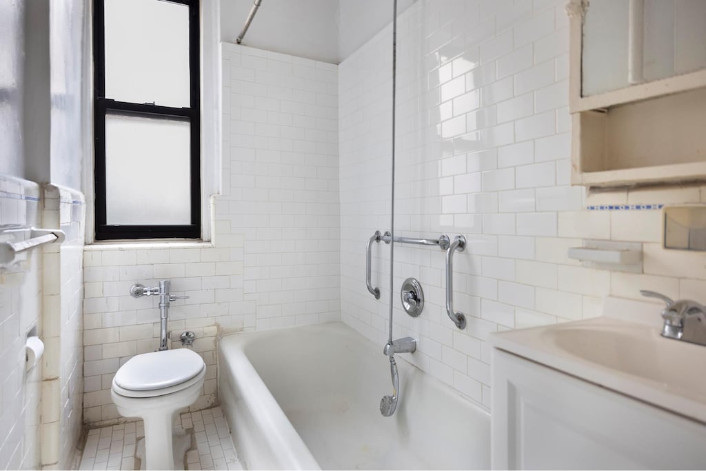 bathroom featuring tile walls, toilet, washtub / shower combination, vanity, and backsplash